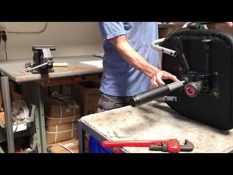 User maneuvering FLUX 360 wheelchair with feet on hardwood floor